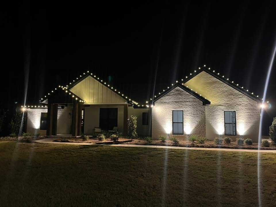 Warm white Christmas lights outlining modern home gables